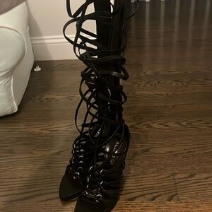 Knee high black strap heels